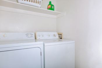washer and dryer with shelving  at Creekview Apartment Homes, Dallas, Texas