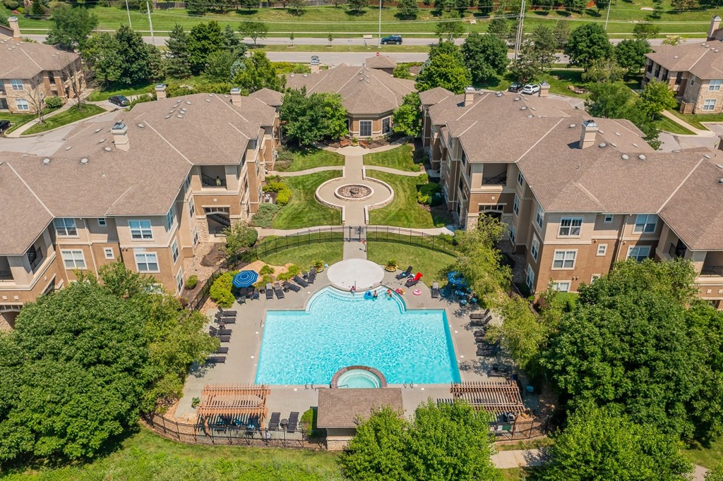 Aerial View An aerial view of a swimming pool and courtyard surrounded by apartment buildings.