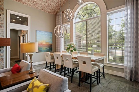 A dining room with a table set for six.