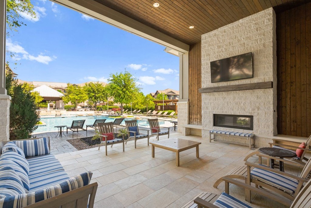 Covered seating area by the pool at Ovation at Lewisville Apartment Homes, Lewisville, TX