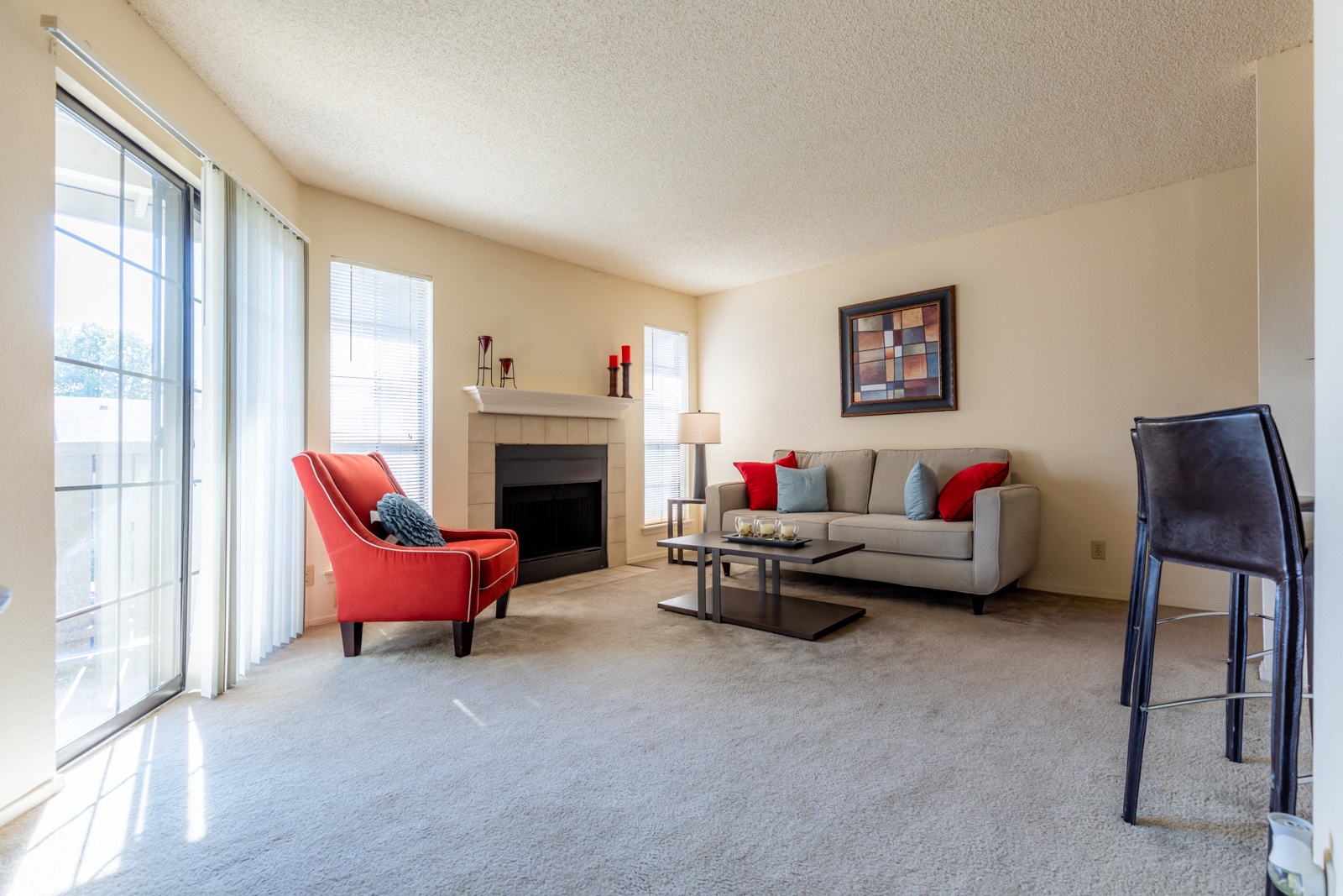 a living room with a couch and a chair and a fireplace