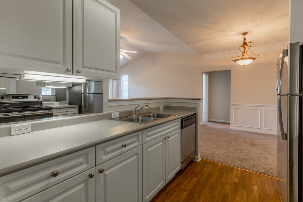 Cabinets and wooden flooring in kitchen at Wynnewood Farms Apartments, Kansas, 66209
