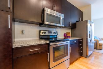 Kitchen counter table and appliances with cabinets1at West 39th Street Apartments, Kansas City, MO