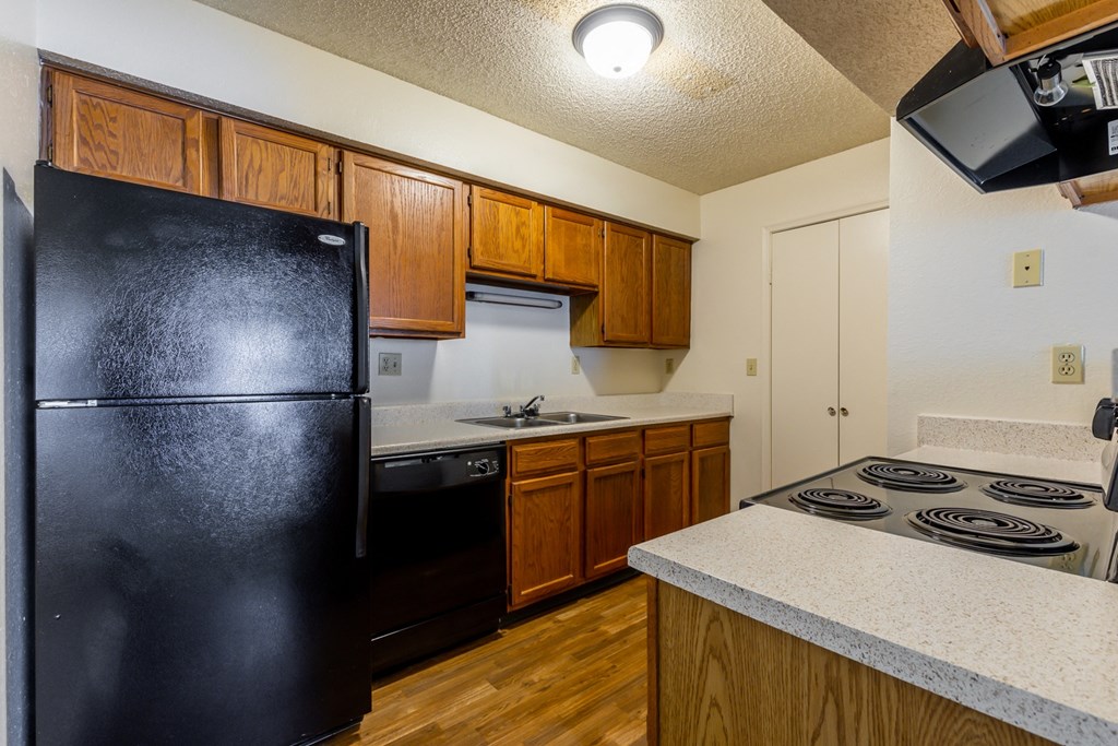 Black appliances and wooden cabientsat Coventry Oaks Apartments, Overland Park, KS, 66214