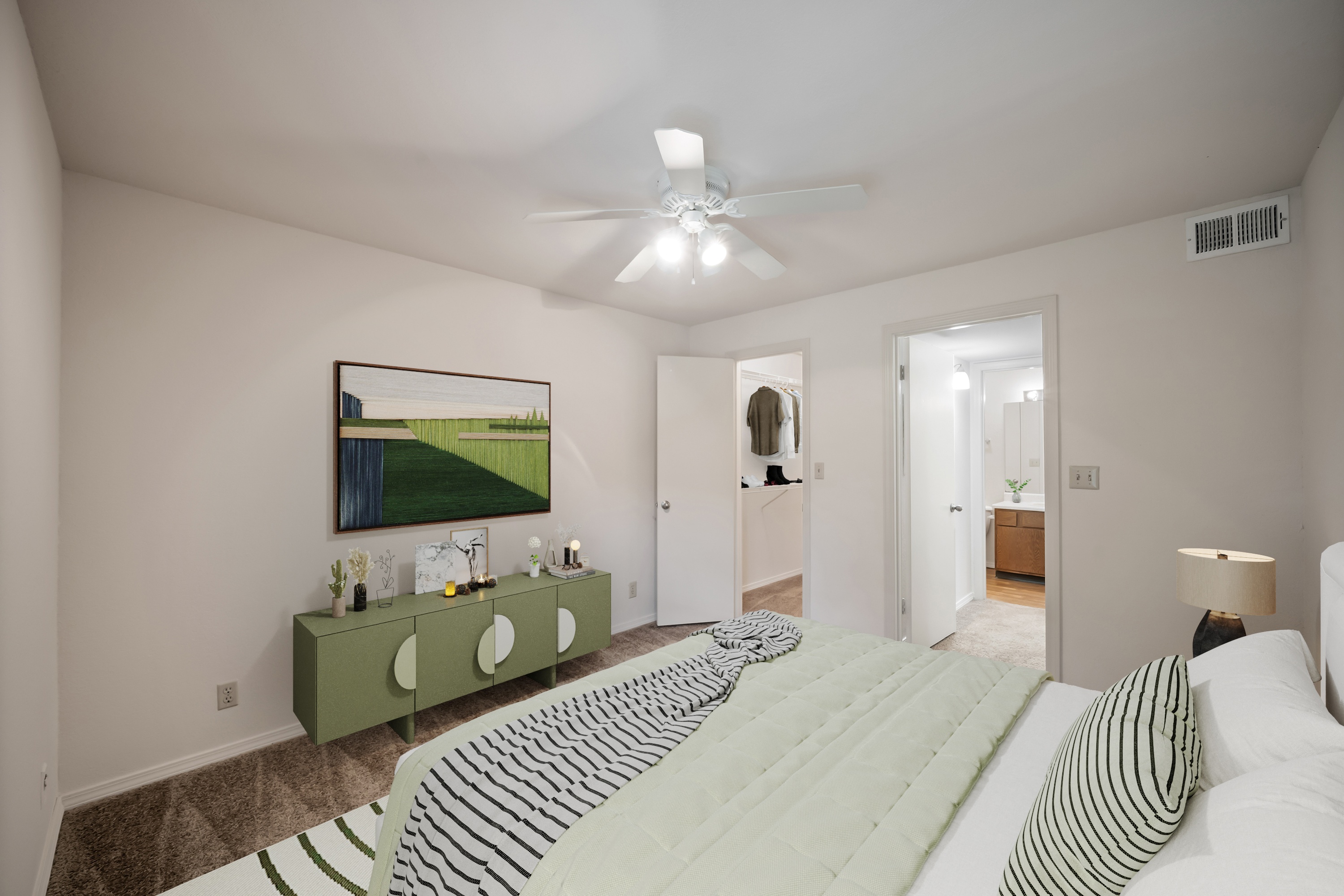 A bedroom with a large bed and a painting on the wall.