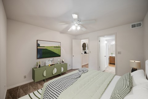 A bedroom with a large bed and a painting on the wall.