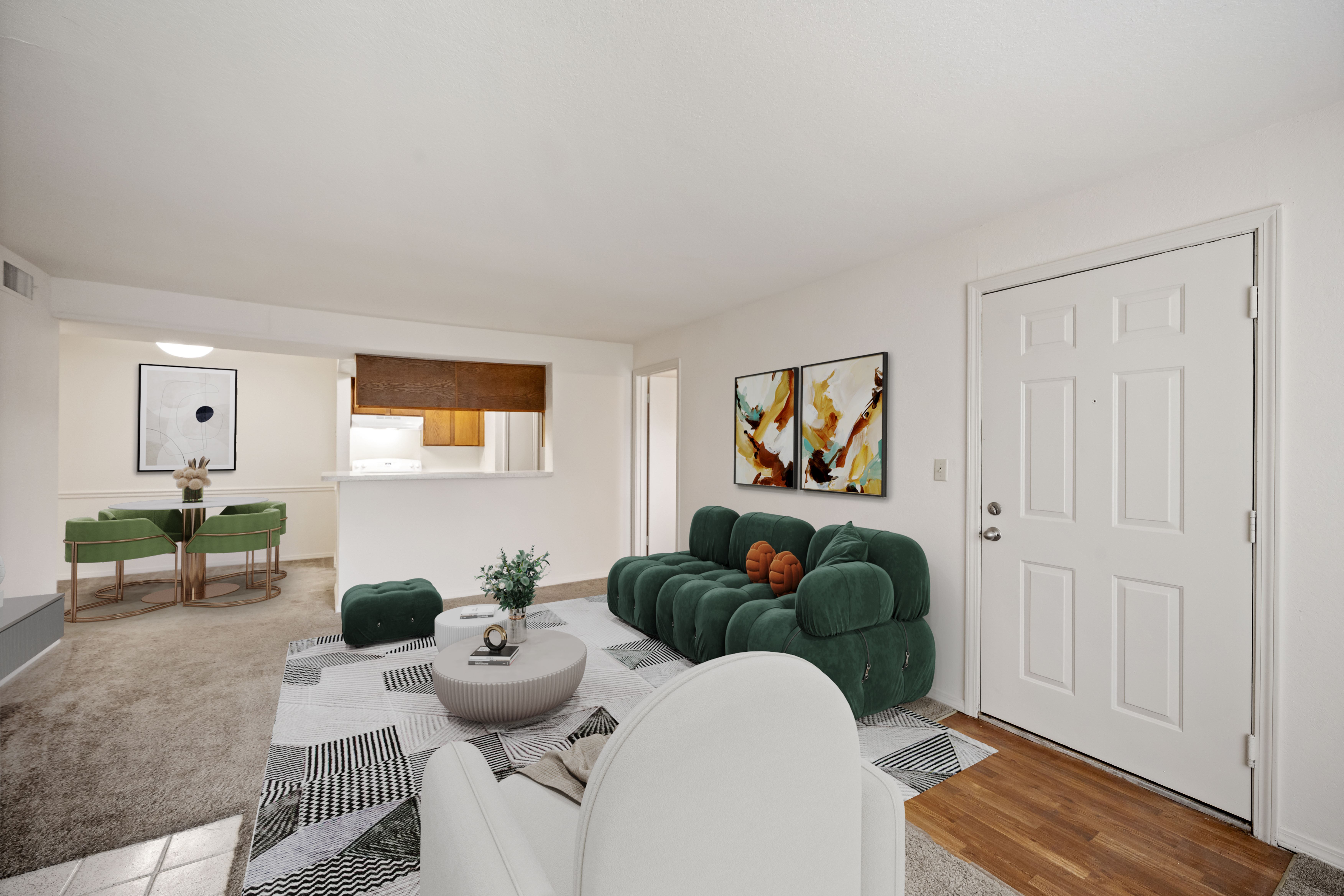 A living room with a white couch and a green sofa.