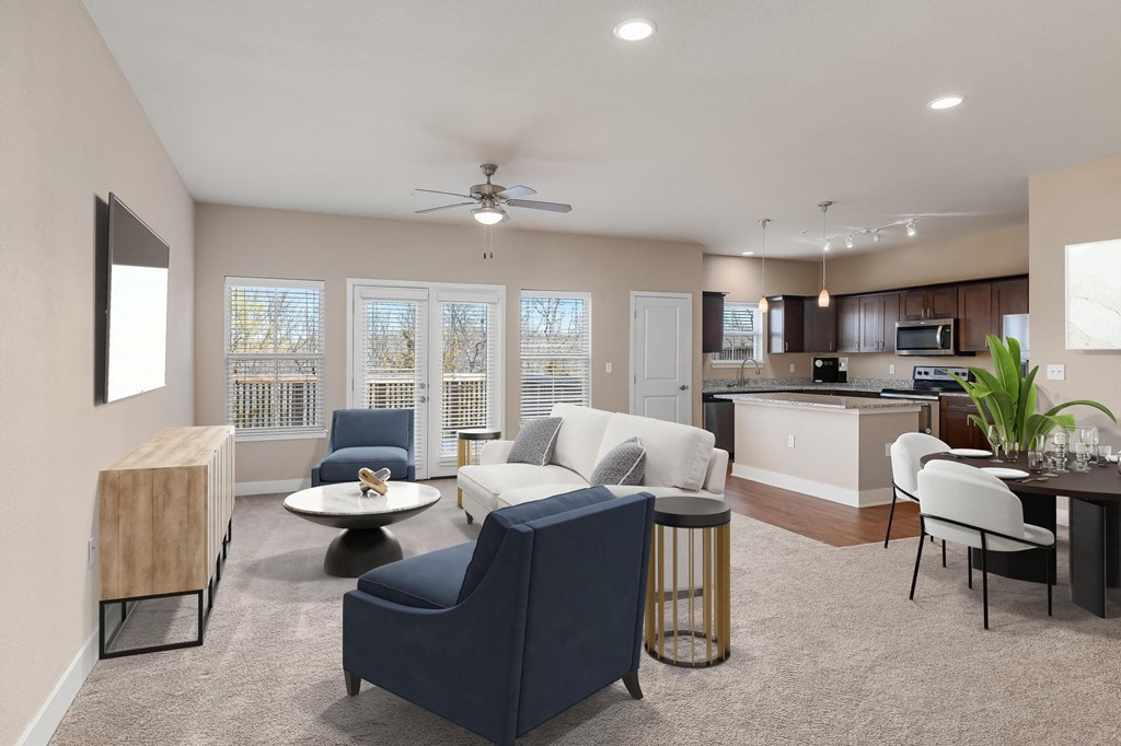 a living room and kitchen with a couch and chairs