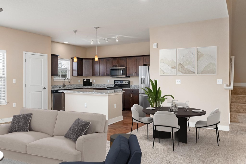 a living room and kitchen with a couch and a table