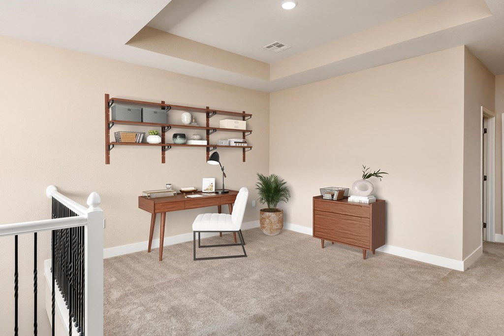 the landing of a home office with a desk and a chair