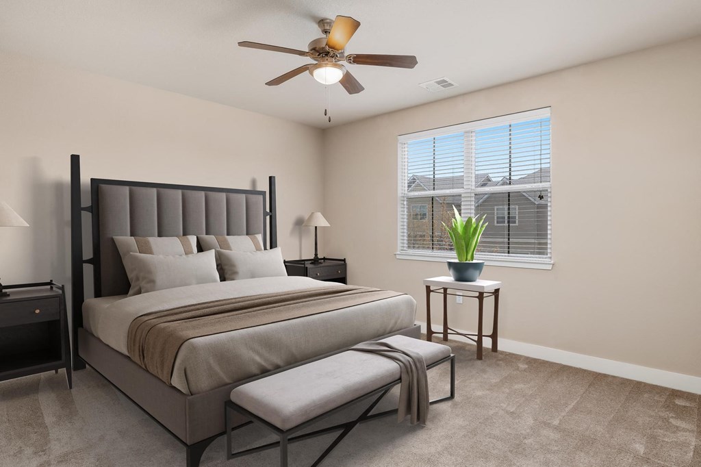 a bedroom with a bed and a ceiling fan