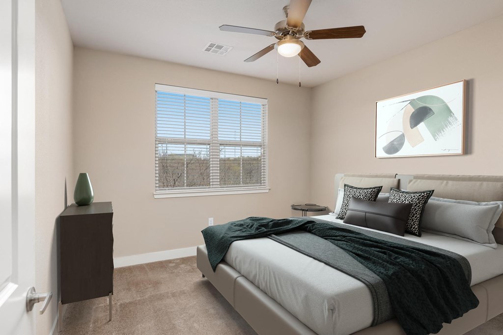 a bedroom with a bed and a ceiling fan