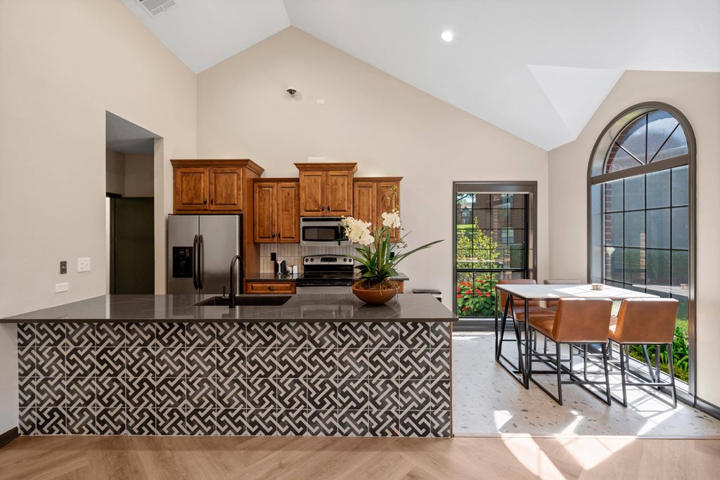 A kitchen with a black and white patterned bar. at Highland Park Apartment Homes, Overland Park, Kansas
