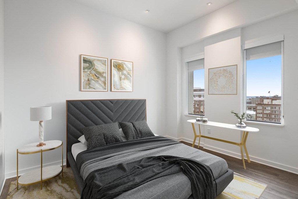 Bedroom with black bedsheets at Sky On Main Apartments, Missouri City, MO, 64105