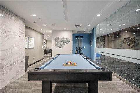 Resident game room at Sky on Main featuring a pool table, modern décor, and access to adjacent community spaces.