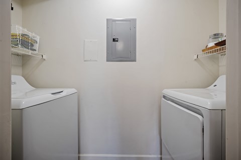 Laundry closet with washer and dryer inside Stonebriar Apartments unit