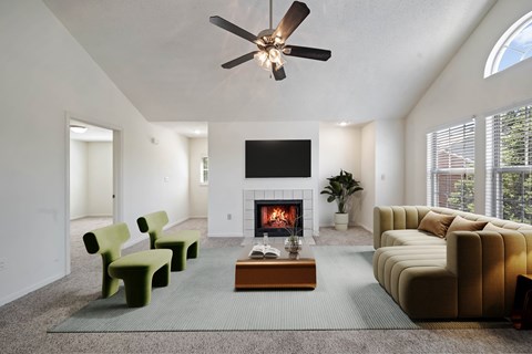 Bright living room with fireplace and high ceiling at Stonebriar Apartments Overland Park KS