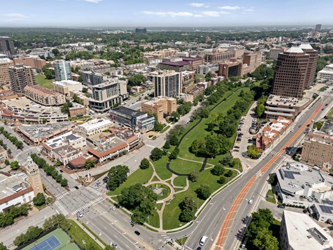 Aerial view of West Plaza neighborhood near The Dorset with shops, streets, and green space