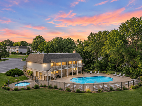 A large house with a pool in the backyard.