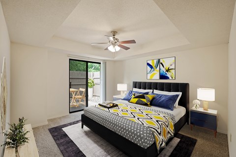 A bedroom with a bed, nightstand, and a ceiling fan.