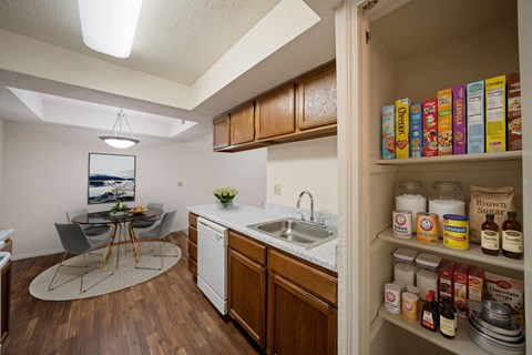 A kitchen with a white fridge and a white sink.