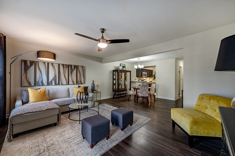 A living room with a grey sofa and a yellow chair.
