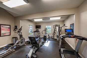 the gym with plenty of cardio equipment at our apartments