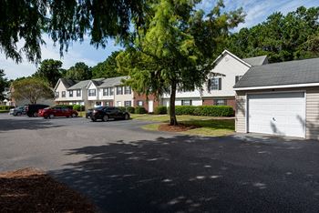 a city street with cars parked in front of houses