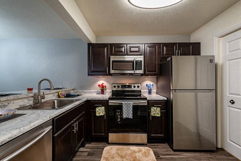 a kitchen with stainless steel appliances and granite counter tops