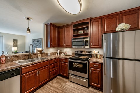 A kitchen with wooden cabinets and stainless steel appliances.