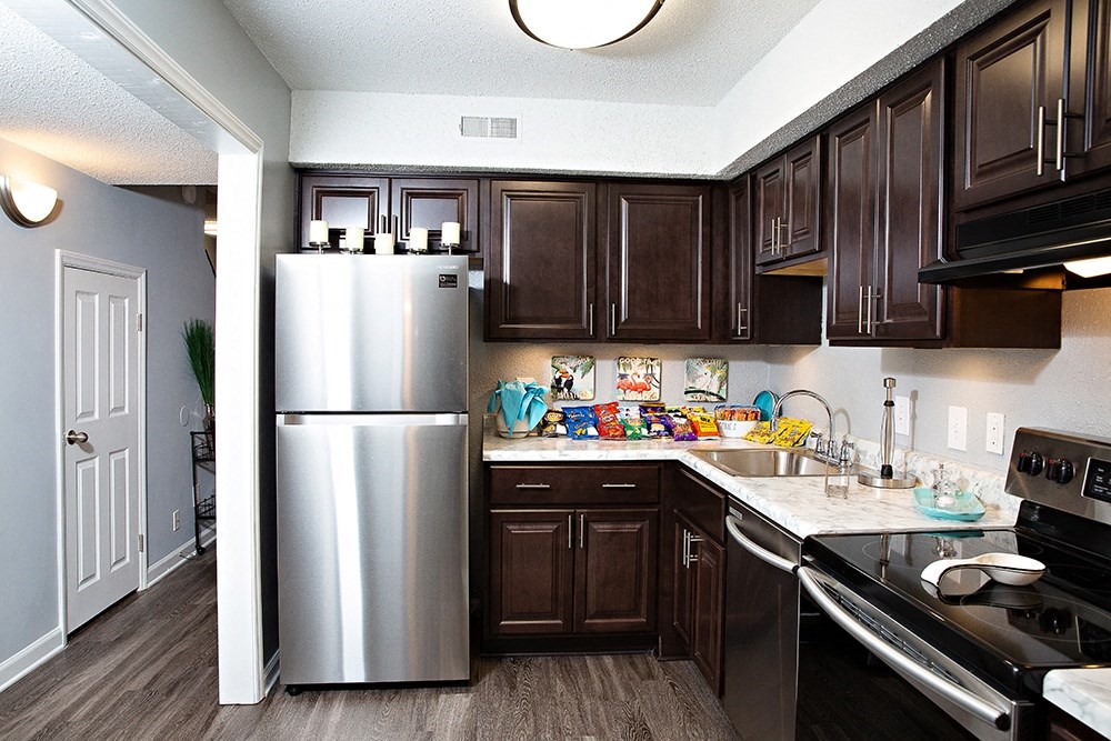 Kitchen with dark cabinets and stainless steel appliances Kitchen with dark cabinets and stainless steel appliances