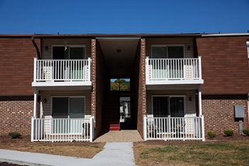an exterior view of an apartment building with two balconies
