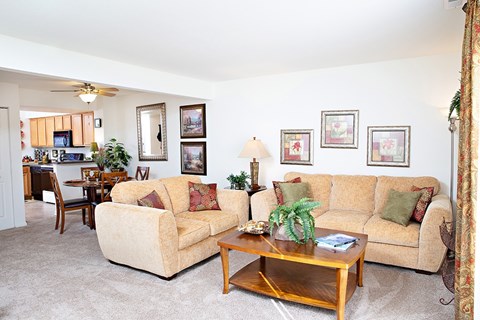 A living room with a tan couch and a coffee table.