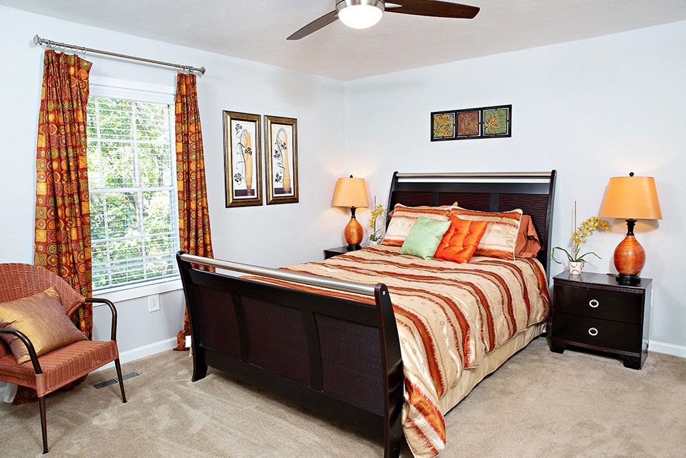 a bedroom with a bed and a ceiling fan