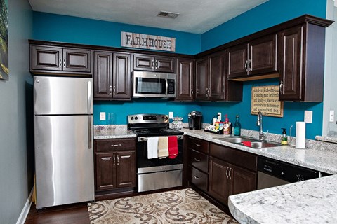 a kitchen with stainless steel appliances and wooden cabinets