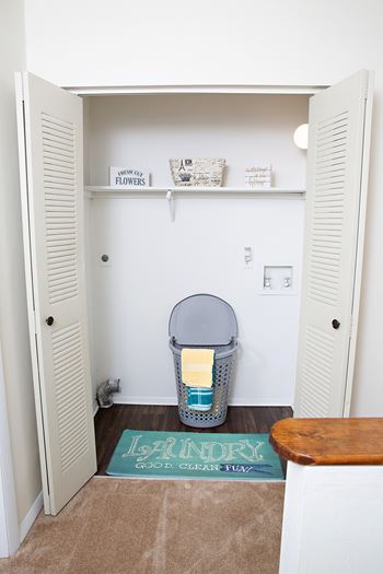 A white closet with a sign that says "flowers" on the shelf.