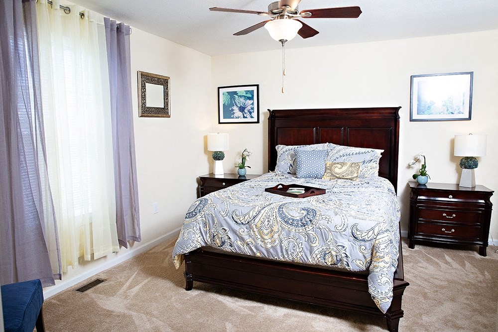 Bedroom with queen bed, dresser and night stands
