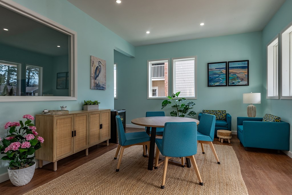 A dining room with a table set for four.
