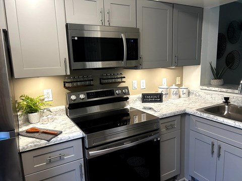 A kitchen with a black oven and a black microwave.