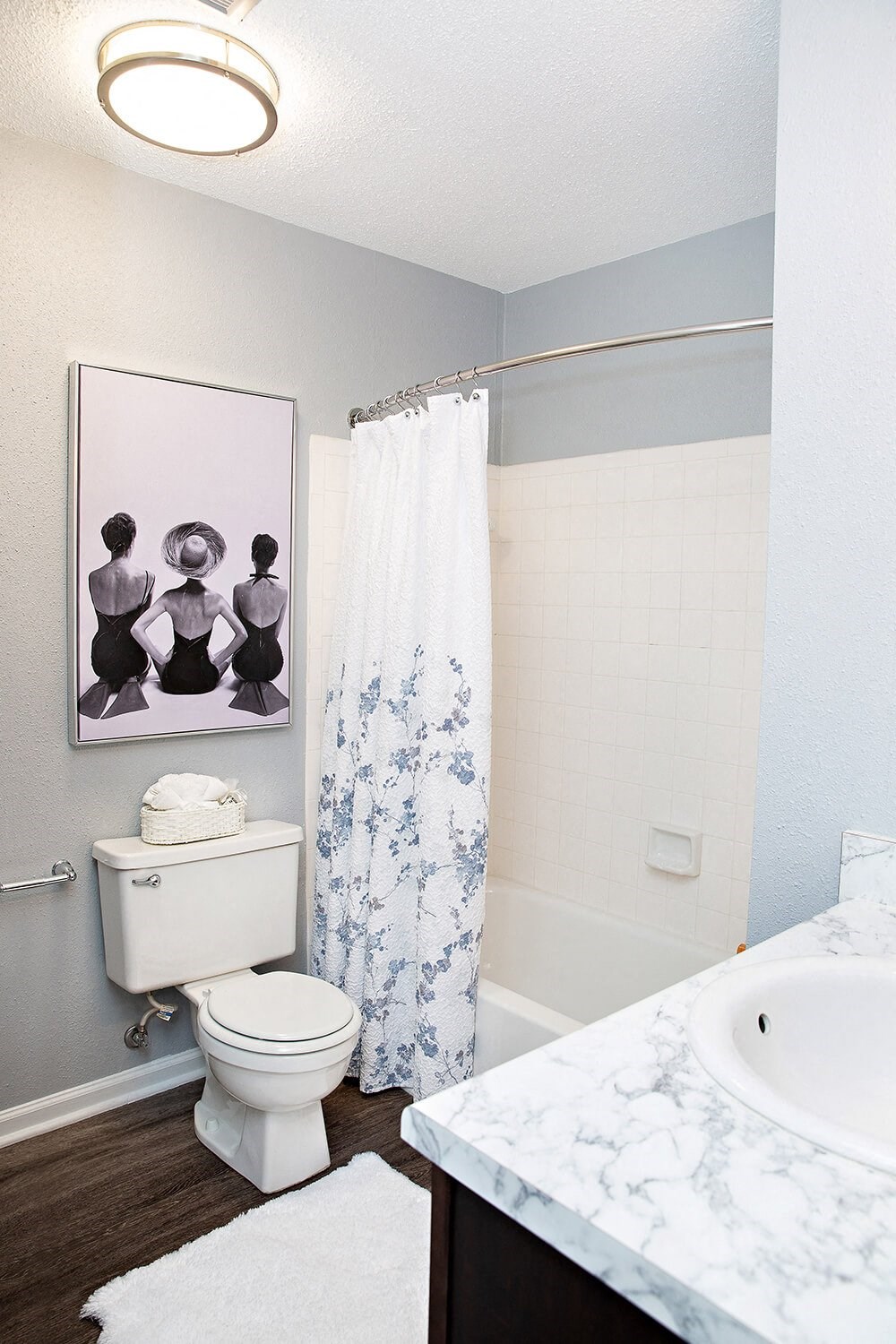 a bathroom with a toilet and a tub and a sink