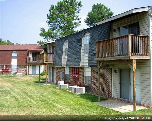 an apartment building with a porch and a balcony