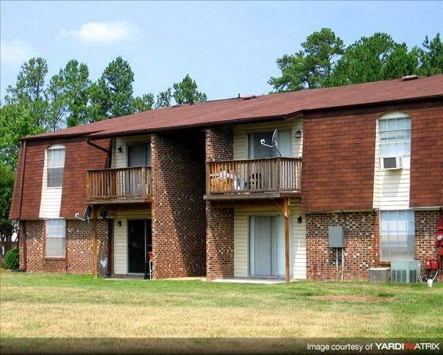 a brick apartment building with two balconies