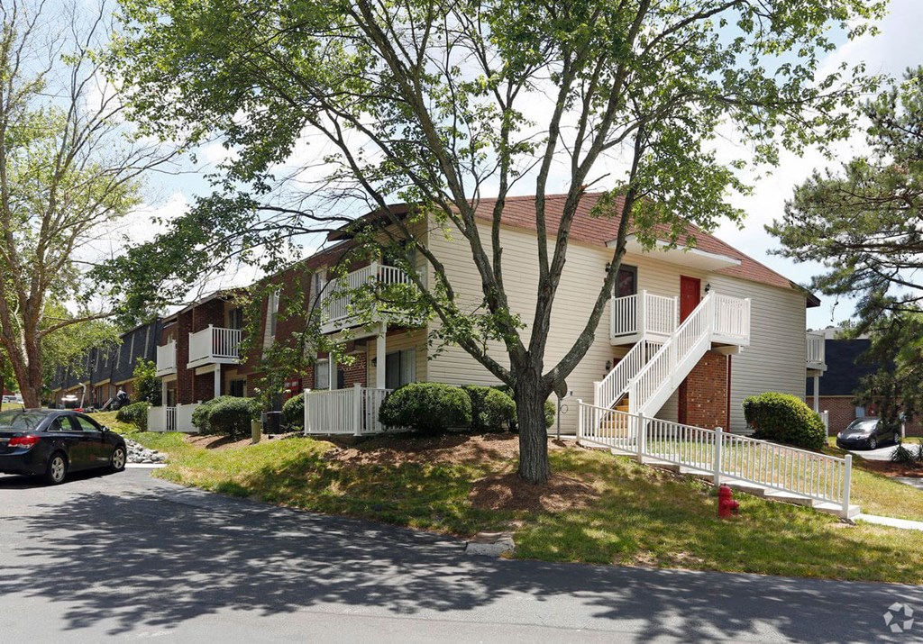 a row of houses on a street with a red fire hydrant