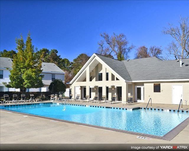 a large swimming pool with a building in the background
