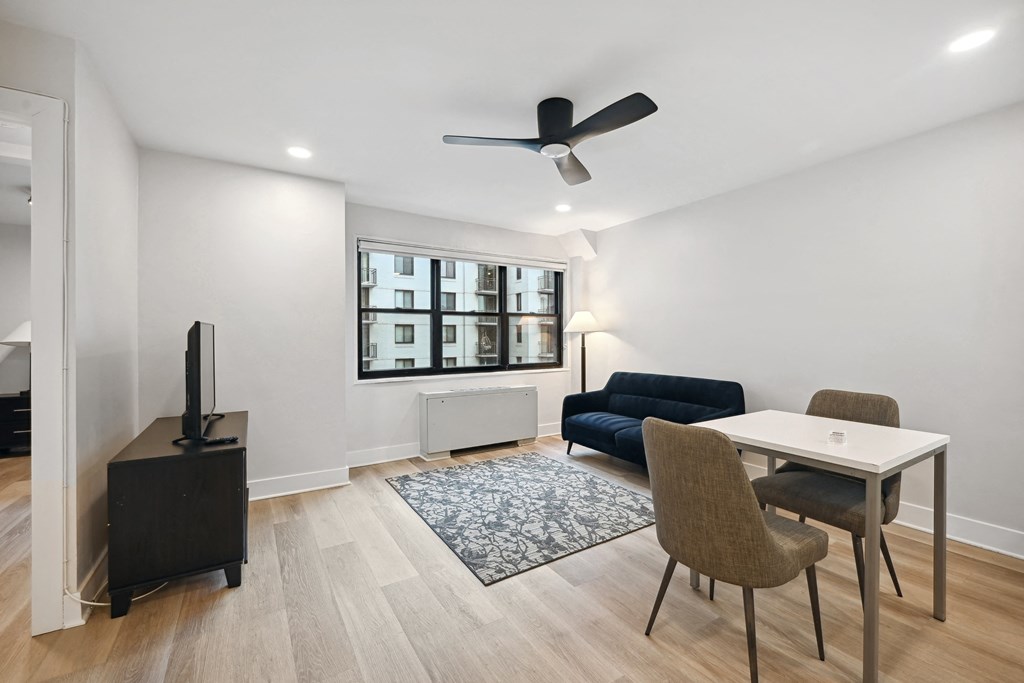 a living room with a couch and a table with chairs