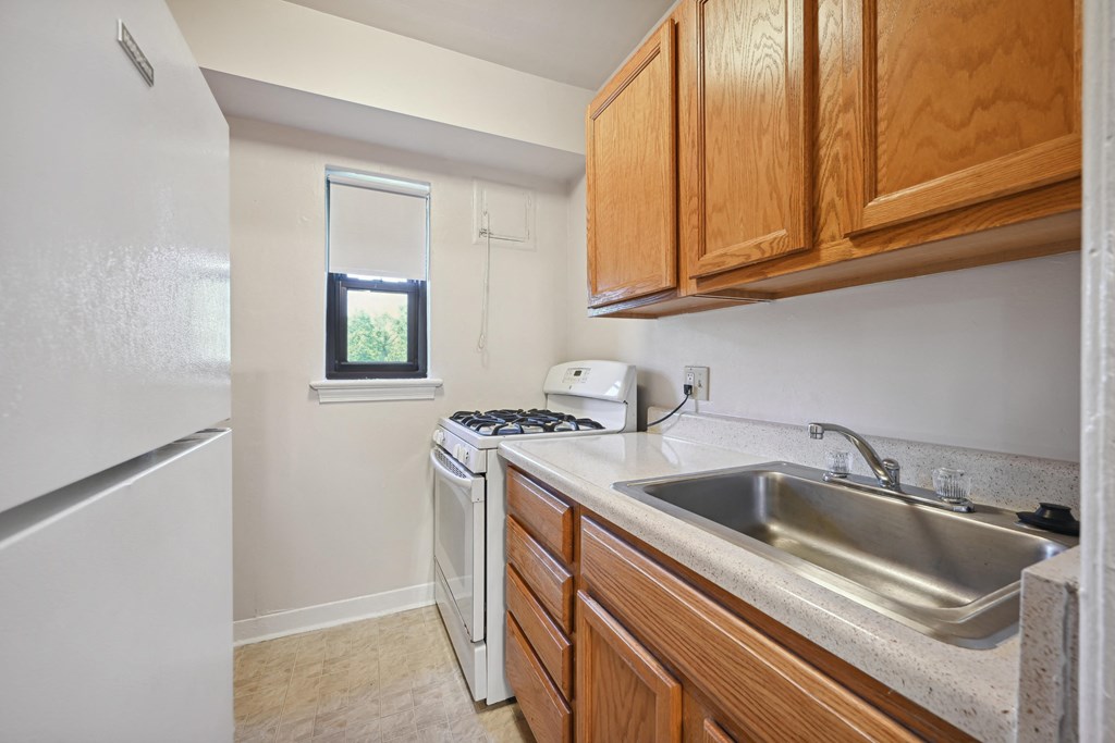 a kitchen with a sink and a stove and a window