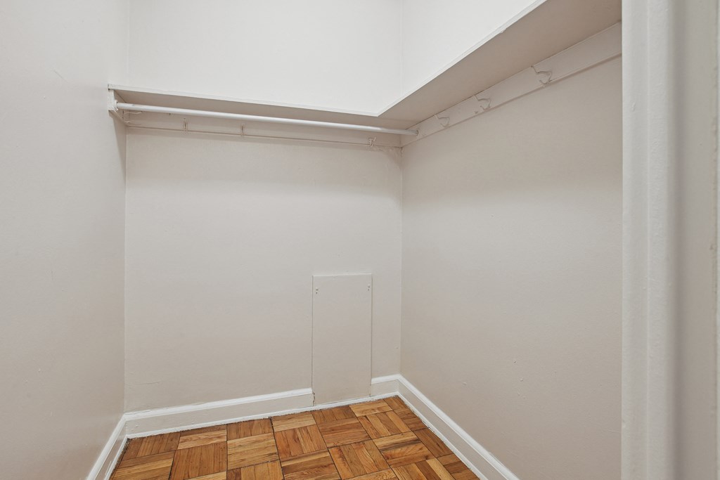 a small room with white walls and a wooden floor