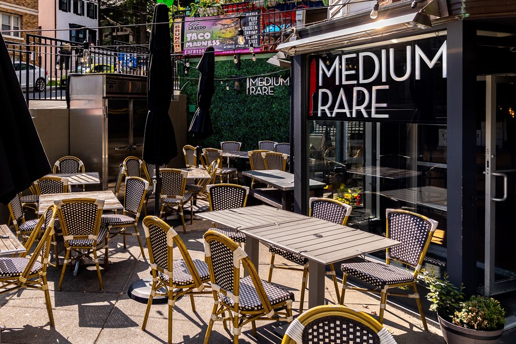 a patio with tables and chairs outside of a restaurant
