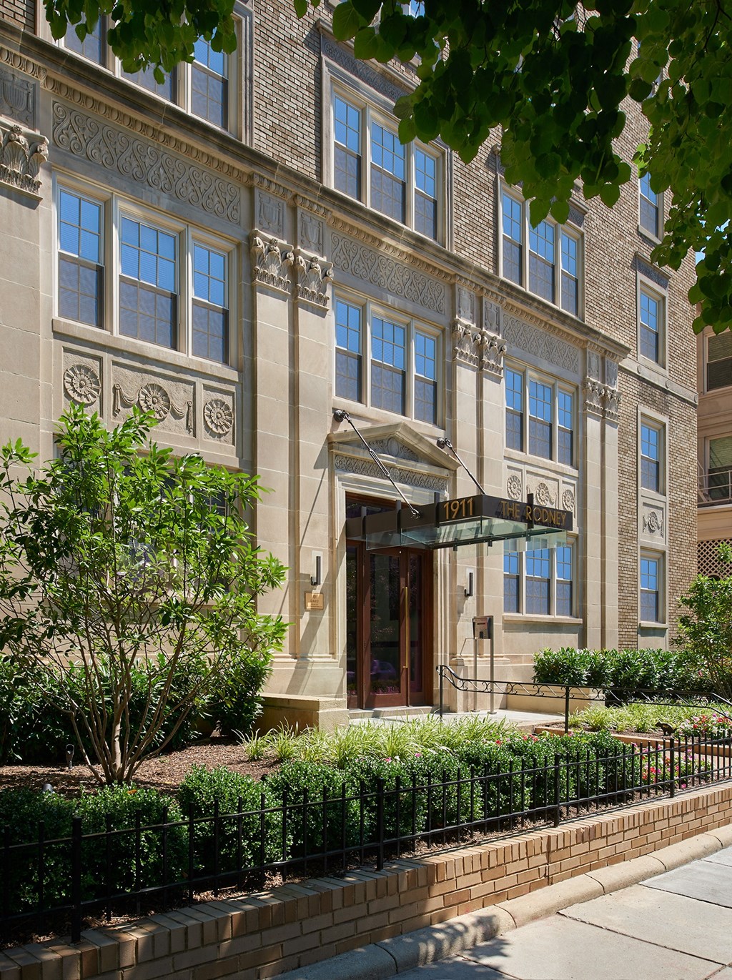 a large building with a sidewalk in front of it