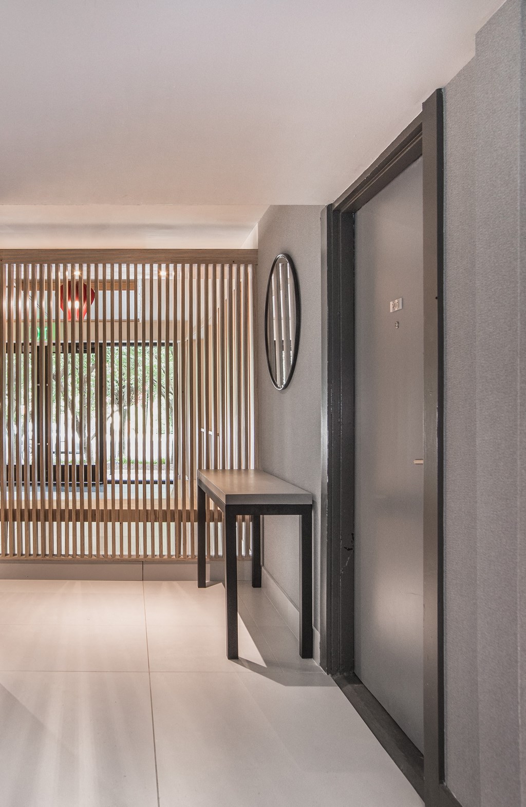 a hallway with a table and a mirror on the wall